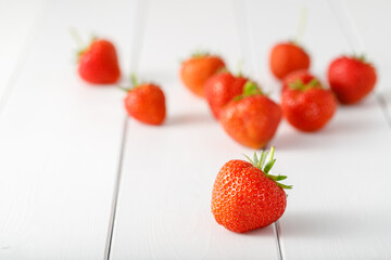 Fresh sweet strawberry closeup on a white wooden background