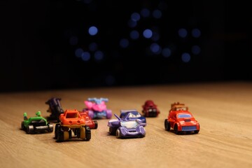 small children's cars in miniature on a wooden background