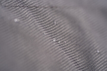 Grey textile texture with water drops