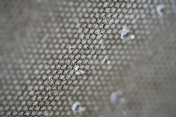 Grey textile texture with water drops