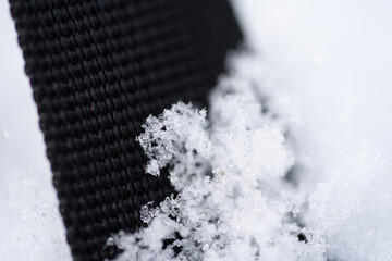 Black textile textures with icy snow flakes