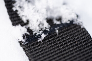 Black textile textures with icy snow flakes