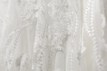 Fototapeta na wymiar Delicate white wedding dress detail close up of lace stitching