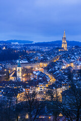 Old town of Bern in winter blue hour with snowy and illuminated buildings, Bern, UNESCO, Switzerland - obrazy, fototapety, plakaty