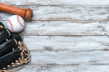 Baseball bat, glove and ball on wooden background.  Sport theme background with copy space for text...