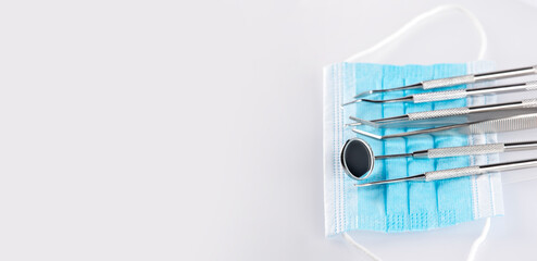 Dentist tools and mask on white background. Dental banner or background