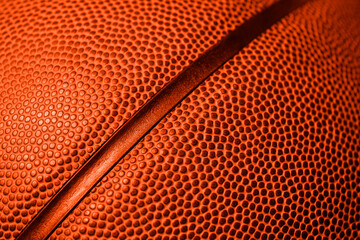 Closeup detail of basketball ball texture background. Orange color filter. Banner art concept. Team sport