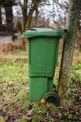 Fototapeta premium green waste bin in the garden