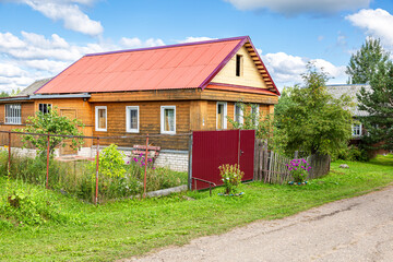 Fototapeta na wymiar Typical rural wooden house in russian village with new roof