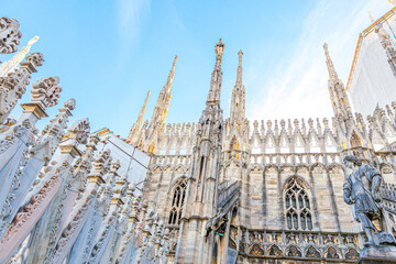 Roof of Milan Cathedral Duomo di Milano with Gothic spires and white marble statues. Top tourist...