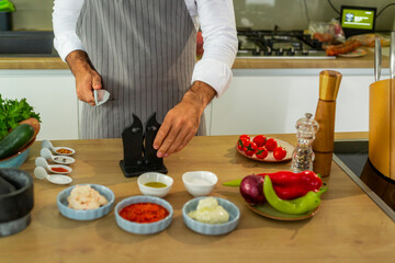 The cook sharpens the knives before preparing the food