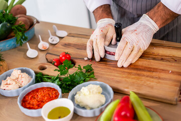 The chef shapes the burgers in the press