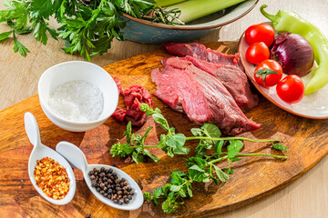 A close-up view of raw meat on a wooden board