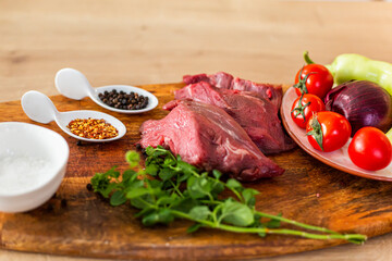 A close-up view of raw meat on a wooden board