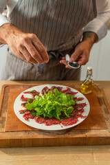 Prepared meat carpaccio on a serving plate
