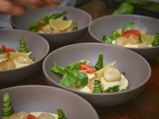 Cucumber and rocket salad with sesame seeds and lemon is on a wooden table. close-up.