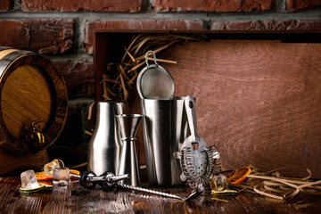 Steel bar tools for making cocktail. Shaker, jigger, strainer, Set of bar accessories on wooden background with copy space