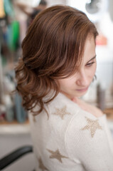 Brown-haired girl in profile with wavy hair