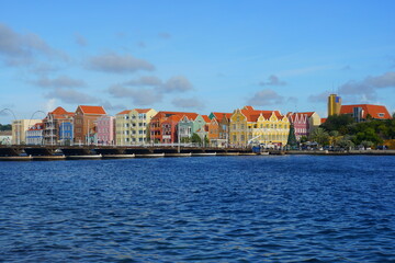 Fototapeta premium The view of the colorful buildings along the St Anna Bay during the day near Willemstad, Curacao 