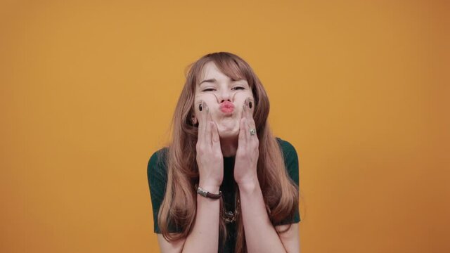 Upset offended looking big eyes, blowing cheeks being annoyed after quarrel with her husband, inflating not wanting to do something, bad mood, fascinating, cut, pouted. Young attractive woman