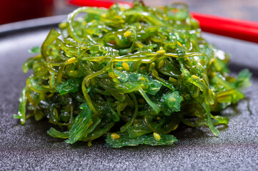 Tasty vegetarian sea food from Japan, green seaweed wakame salad