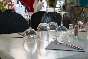 Before lunch time, empty stylish cafes with served tables waiting for guests in Saint-Tropez, Provence, France