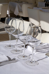 Before lunch time, empty cafes with served tables and tablecloths waiting for guests in Saint-Tropez, Provence, France