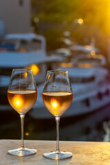 Tasting of local rose wine in summer with sail boats haven of Port Grimaud on background, Provence, France