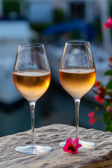 Tasting of local rose wine in summer with sail boats haven of Port Grimaud on background, Provence, France