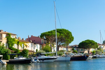 Fototapeta na wymiar Travel and vacation destination, view on houses, roofs, canals and boats in Port Grimaud, Var, Provence, French Riviera, France