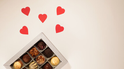 Candies in the box. Valentine's day background. Copy space. Hearts made of paper 