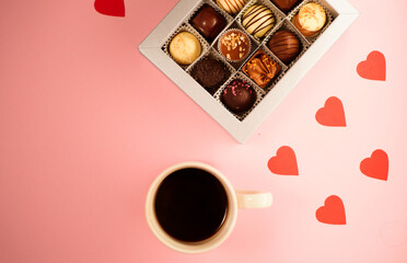 Valentine's day gift. Chocolate candies box with cup of coffee. Pink background. Vertical orientation 