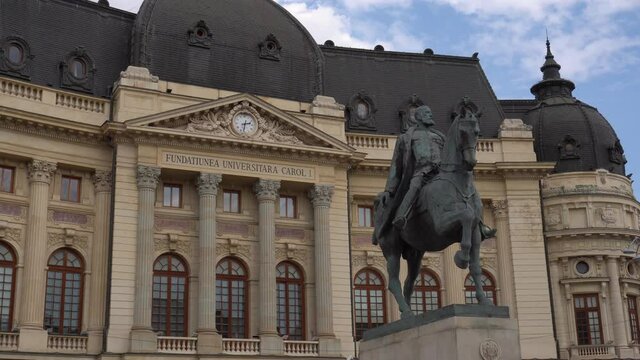 4k video of The Bucharest National Central University library building with statue of King Carol I Of Romania. Travel video with city architecture