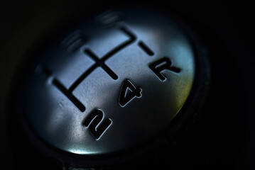 The gear lever in the car. Close-up gear shift knob with digital gear markings.