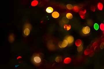 Multi-colored abstract bokeh on a black background, bright lights