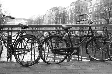 Fototapeta na wymiar Bicycles on Amsterdam Bridge in Black and White