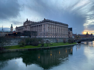 Fototapeta na wymiar Swedish parliament in sunset surrounded with water in grey afternoon