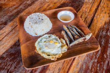 Breakfast in Philippines - rice, fries fish and egg