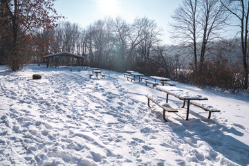 Snow covered picnic tables and area in William O'Brien State Park Minnesota