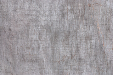 texture of gray faded plywood with cracks, streaks and stains from damp and bad weather