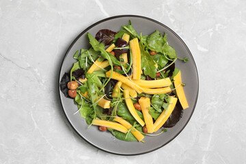 Delicious fresh carrot salad served on grey marble table, top view