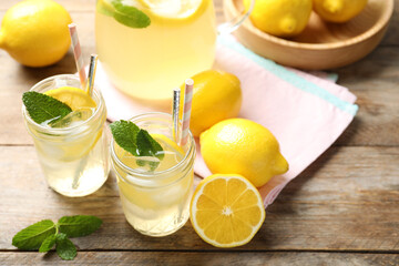 Natural lemonade with mint and fresh fruits on wooden table. Summer refreshing drink