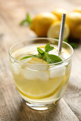 Natural lemonade on wooden table, closeup. Summer refreshing drink