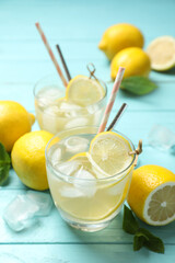 Natural lemonade and fresh fruits on light blue wooden table. Summer refreshing drink