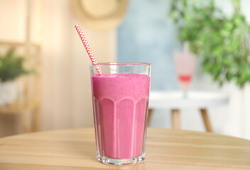 Tasty fresh milk shake on wooden table indoors
