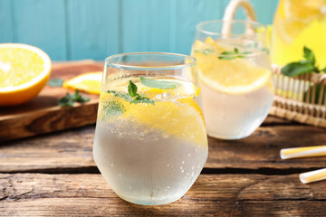 Delicious refreshing citrus drink on wooden table