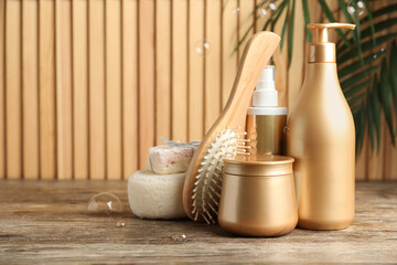 Composition with hair care cosmetic products on wooden table. Space for text