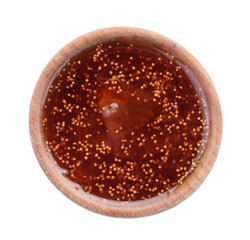 Homemade delicious fig jam in wooden bowl on white background, top view