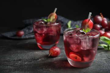 Delicious grape soda water on black table. Refreshing drink