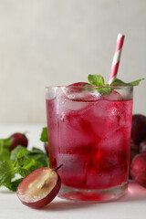 Delicious grape soda water with mint on white table. Refreshing drink